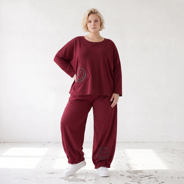 Oversized French Terry Hose in Schwarz mit Smileyprint gesmoktem Saum und weitem Bein