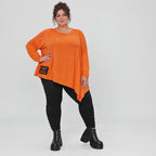 Orange Langarmshirt aus weichem Stretchjersey mit asymmetrischem Schnitt und Zipfelsaum